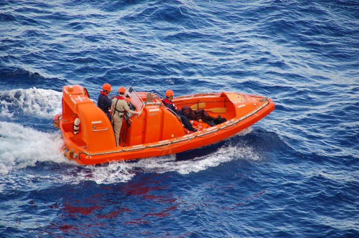 Ocean rescue team in bright orange boat